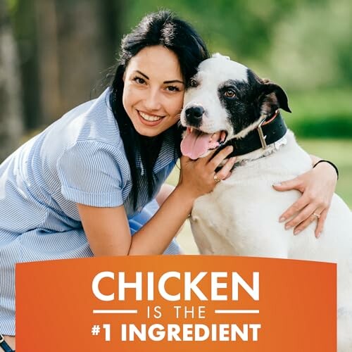 Woman smiling with a dog, text about chicken as number one ingredient.